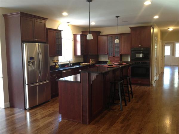 60 Tenney Road Westford, MA 01886 - Photo 5 of 27 a kitchen with kitchen island a wooden floor and a refrigerator