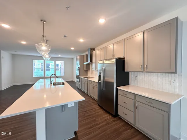 a kitchen with refrigerator and cabinets