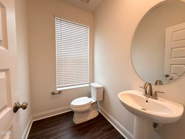 a bathroom with a sink toilet and a mirror