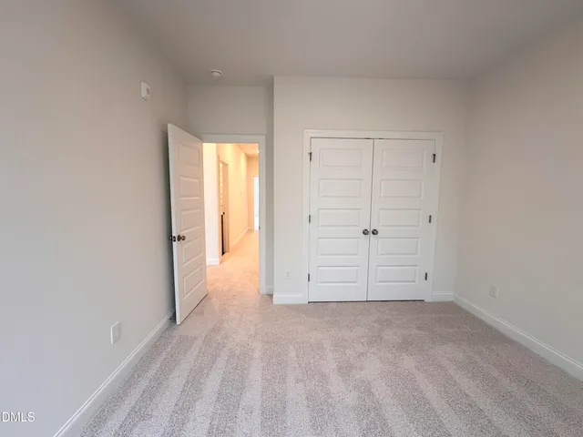 an empty room with cabinet and closet