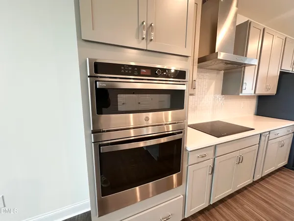 a kitchen with cabinets and steel stainless steel appliances