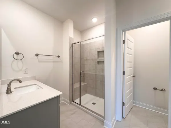 a bathroom with a shower sink and mirror