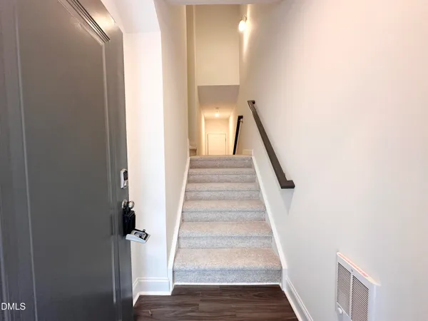 a view of a hallway with wooden floor and entryway