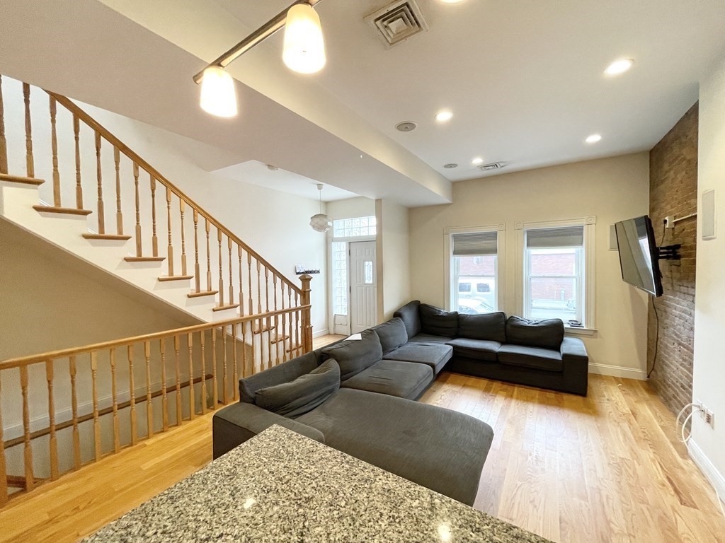 98 L Street, Unit STREET Boston, MA 02127 - Photo 4 of 19 a living room with wooden floor and a couch