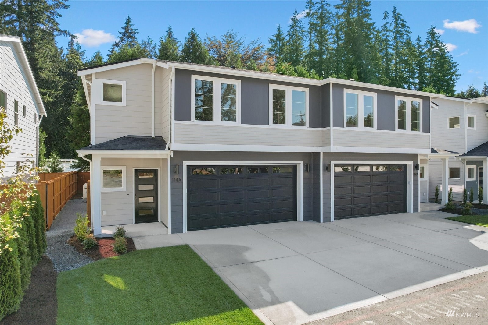114 171st Place Southwest, Unit A Bothell, WA 98012 - Photo 1 of 26 a front view of a house with a yard and a garage