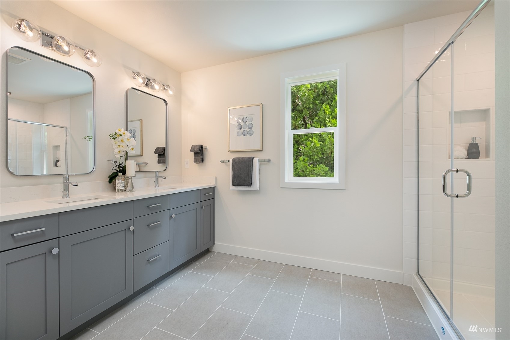 114 171st Place Southwest, Unit A Bothell, WA 98012 - Photo 15 of 26 a spacious bathroom with a double vanity sink a mirror and a shower