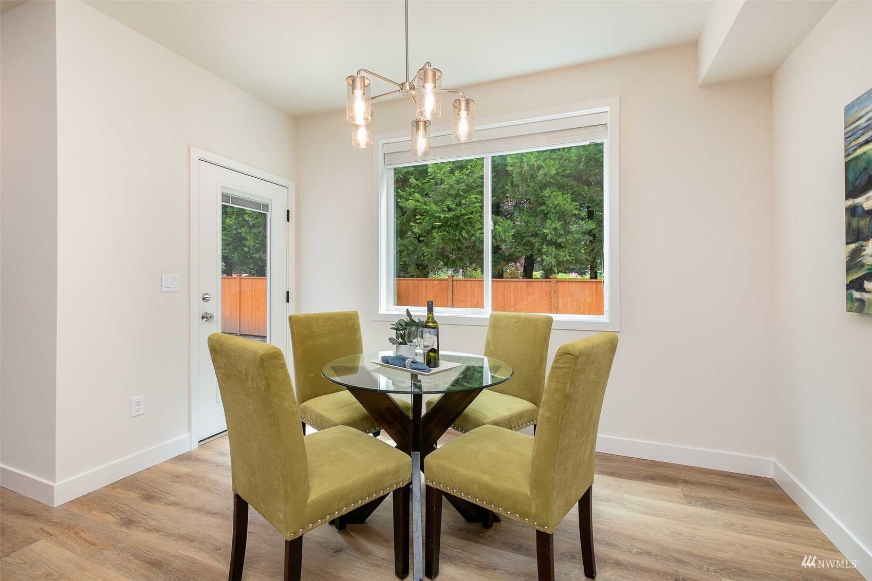 114 171st Place Southwest, Unit A Bothell, WA 98012 - Photo 8 of 26 a dining room with furniture a chandelier and wooden floor