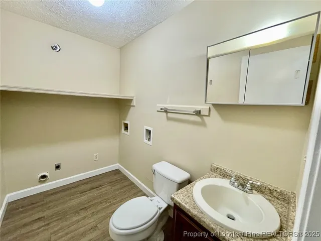 a bathroom with a sink a toilet and mirror