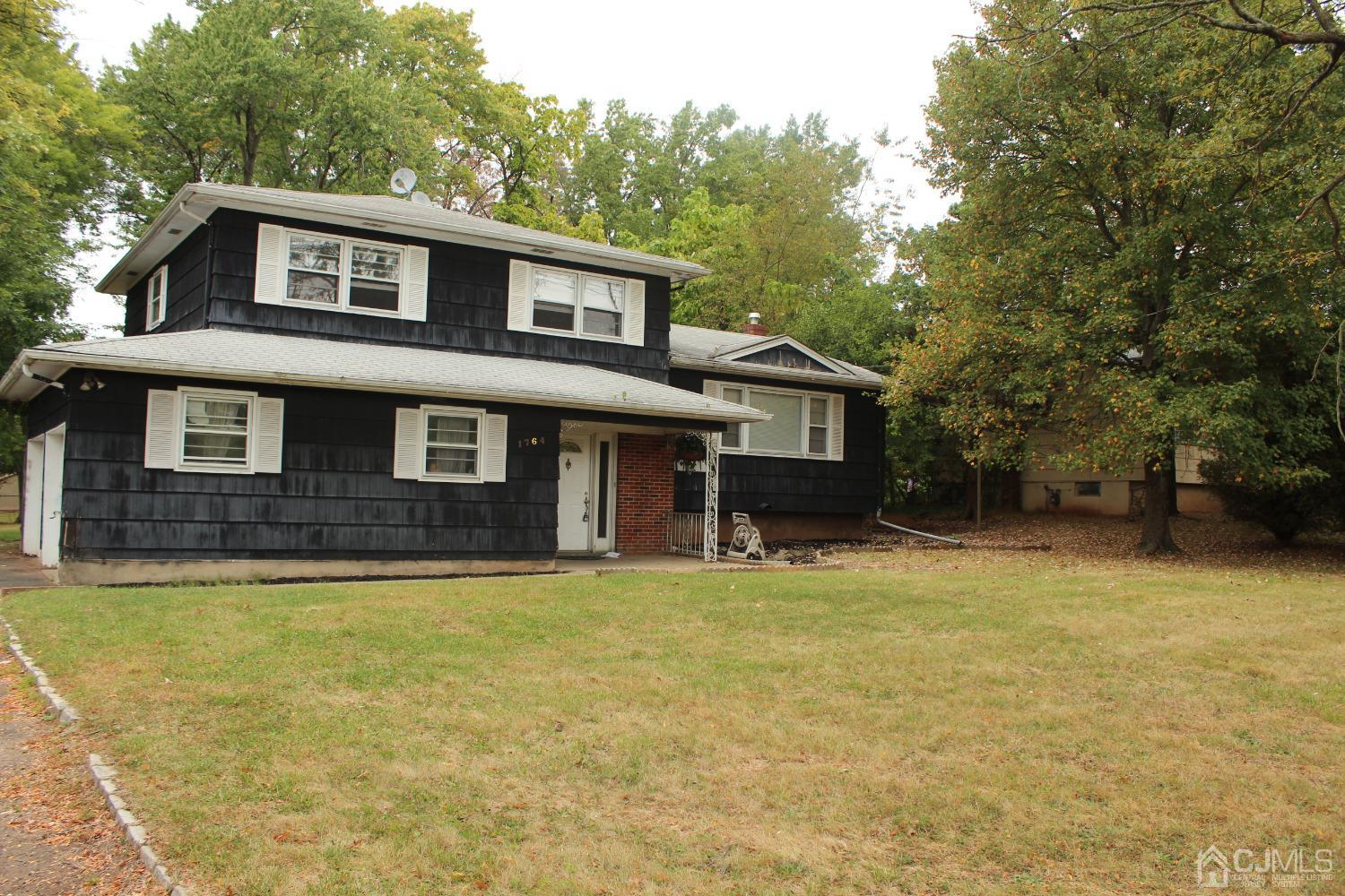 1764 Oak Tree Road Edison, NJ 08820 - Photo 1 of 1 a view of a house with a yard and a tree