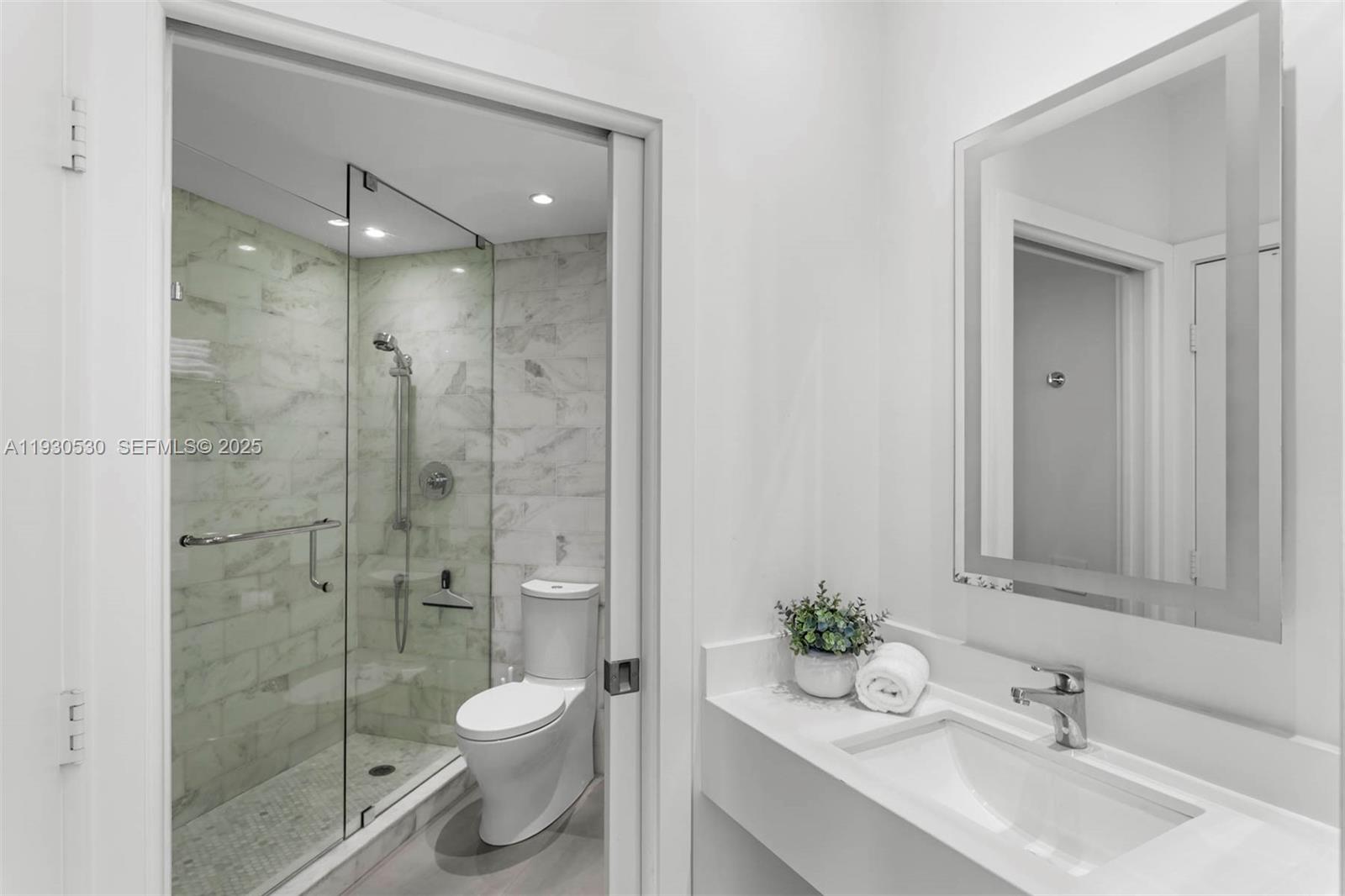 888 Brickell Key Drive, Unit 2606 Miami, FL 33131 - Photo 15 of 32 a bathroom with a sink toilet and shower