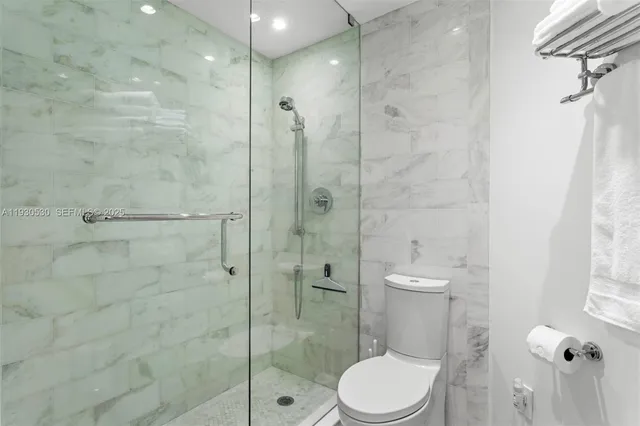 a bathroom with a toilet a sink and shower