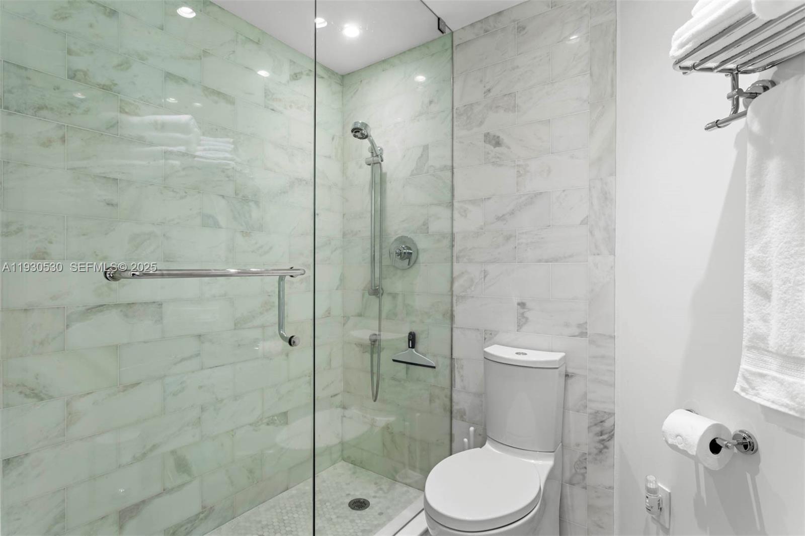 888 Brickell Key Drive, Unit 2606 Miami, FL 33131 - Photo 16 of 32 a bathroom with a toilet a sink and shower