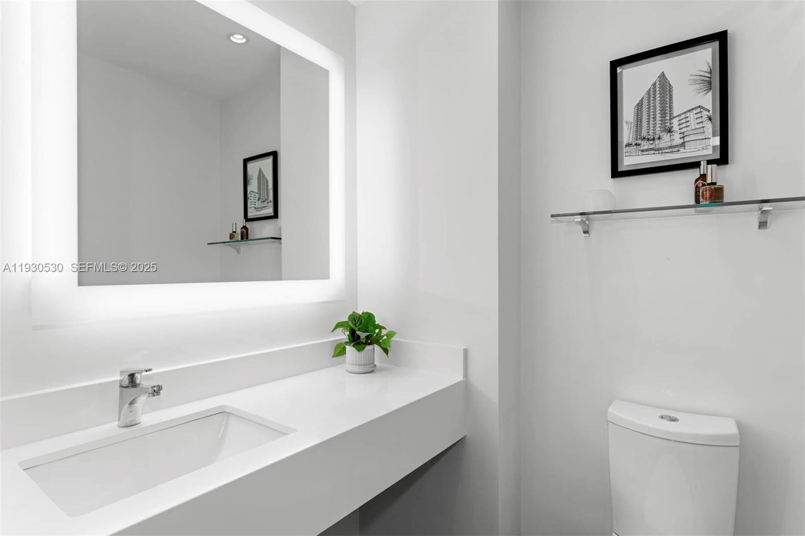 888 Brickell Key Drive, Unit 2606 Miami, FL 33131 - Photo 17 of 32 a bathroom with a sink a toilet and mirror