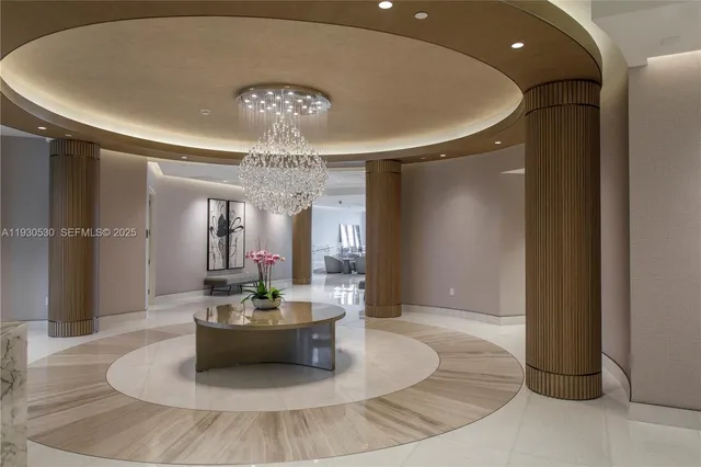 a lobby with furniture and a chandelier
