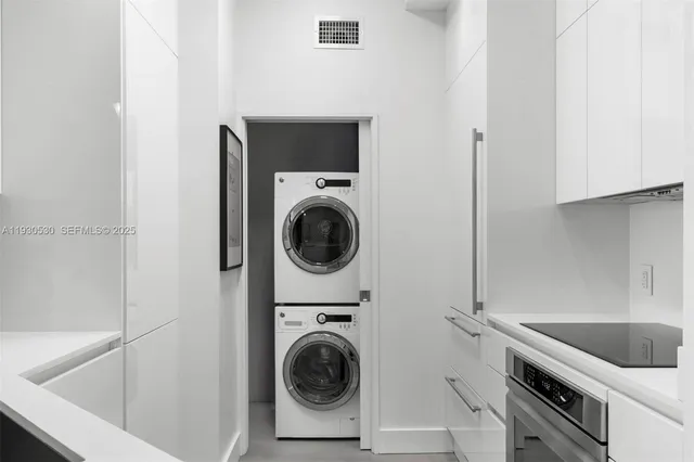 a utility room with sink dryer and washer
