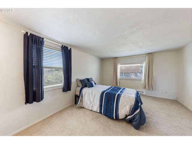 a living room with a bed furniture and a window