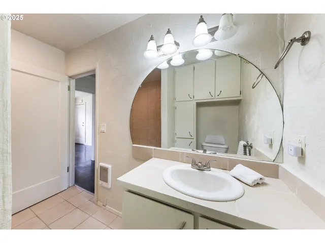 a bathroom with a sink a vanity and a mirror