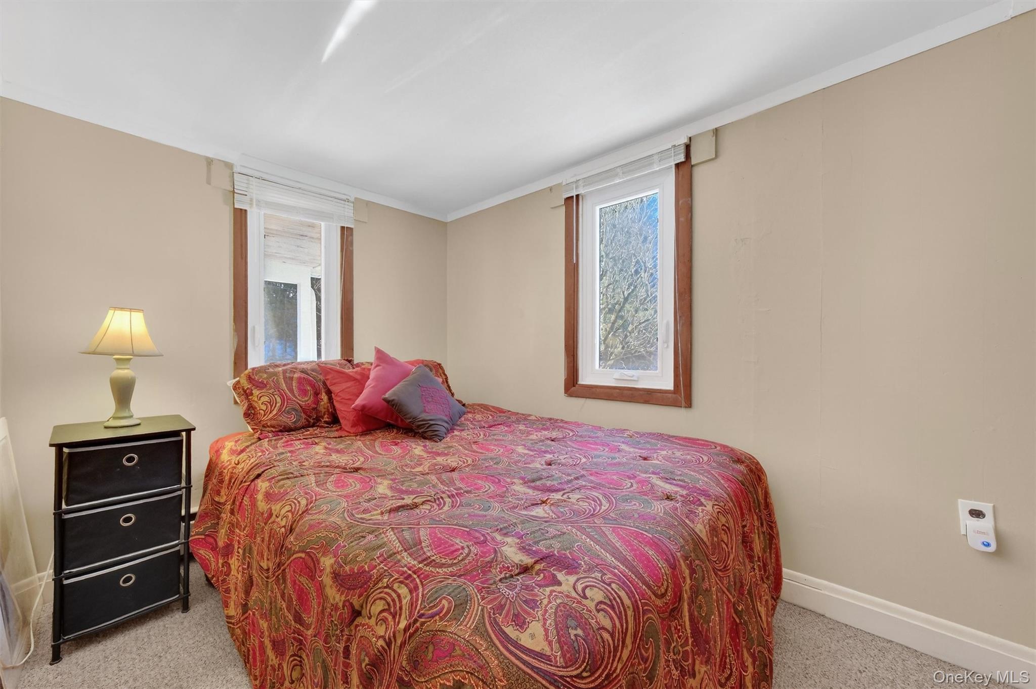 50 Tempaloni Road Ellenville, NY 12428 - Photo 23 of 46 a large bed sitting in a bedroom next to a window and lamp