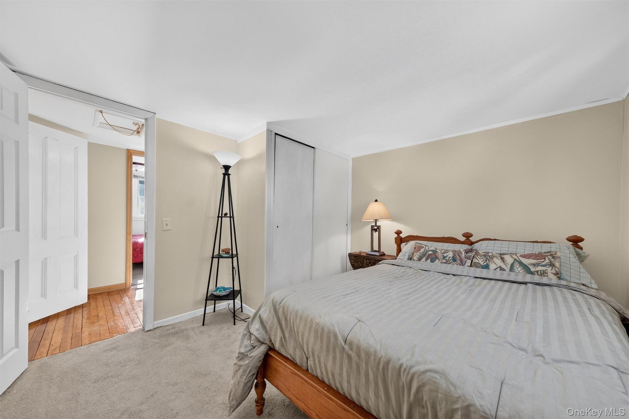 50 Tempaloni Road Ellenville, NY 12428 - Photo 26 of 46 a bedroom with a bed and a chandelier