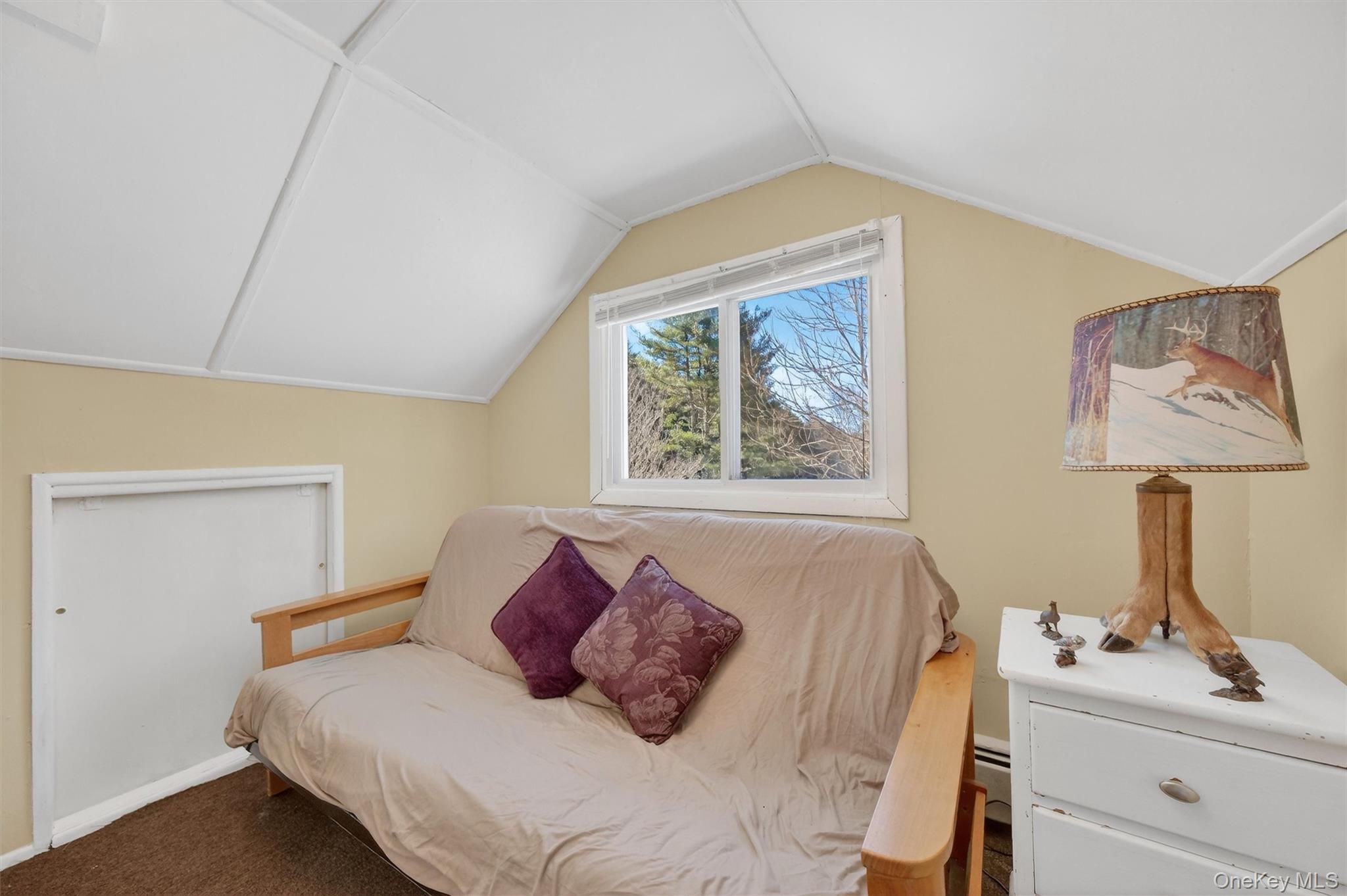 50 Tempaloni Road Ellenville, NY 12428 - Photo 29 of 46 a bedroom with a bed and a lamp on dresser