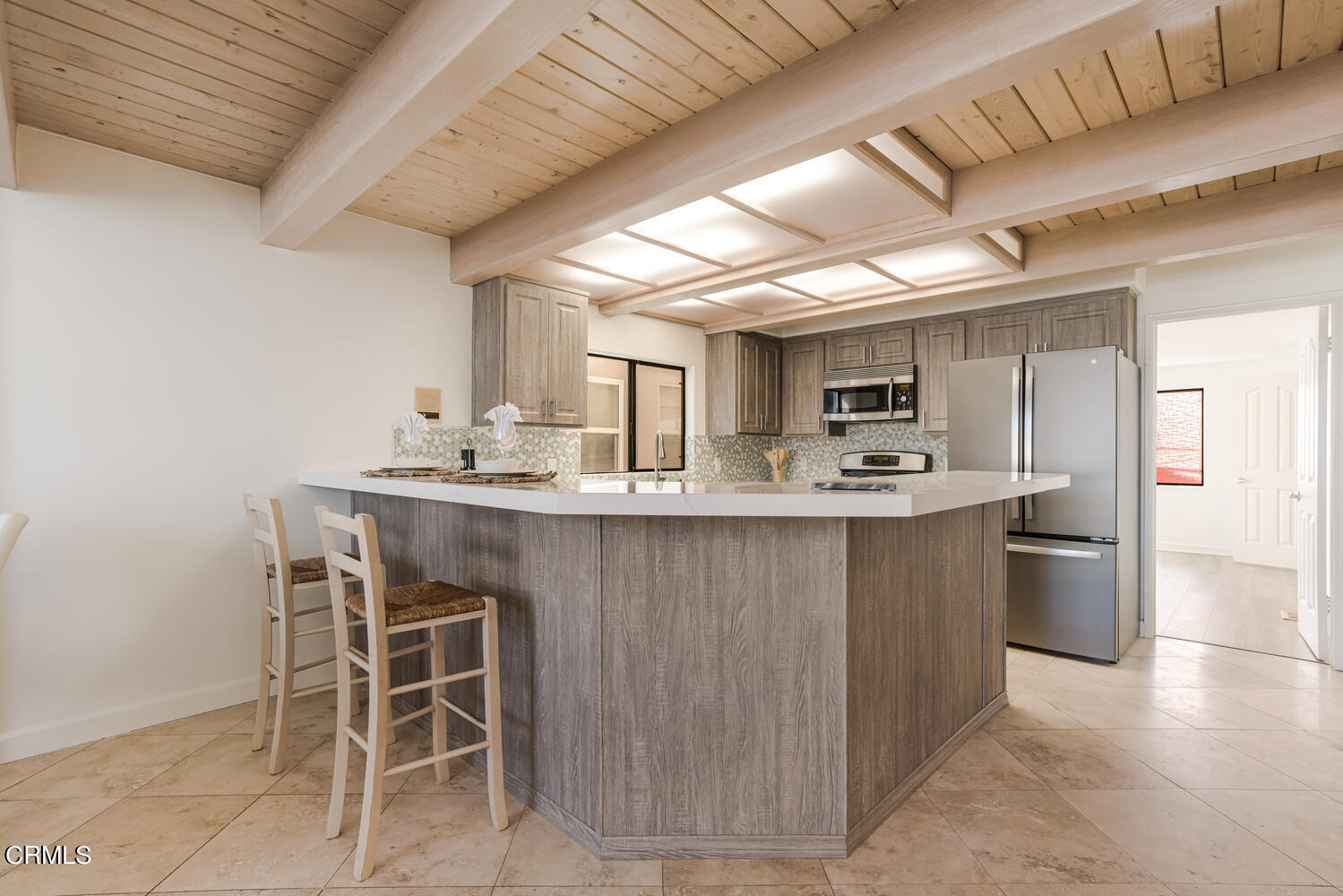 312 Melrose Drive Oxnard, CA 93035 - Photo 17 of 58 a kitchen with kitchen island a sink counter and chairs