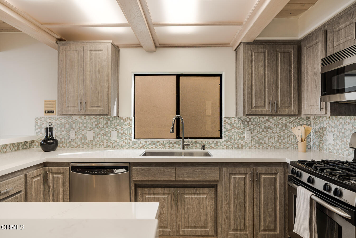 312 Melrose Drive Oxnard, CA 93035 - Photo 19 of 58 a kitchen with stainless steel appliances granite countertop a sink stove and microwave