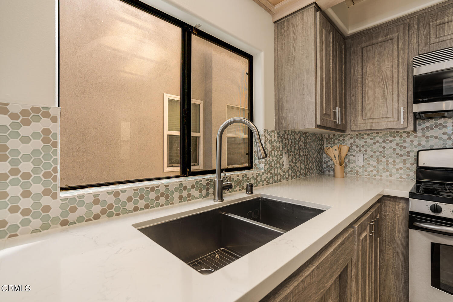 312 Melrose Drive Oxnard, CA 93035 - Photo 20 of 58 a kitchen with granite countertop a sink and a stove top oven