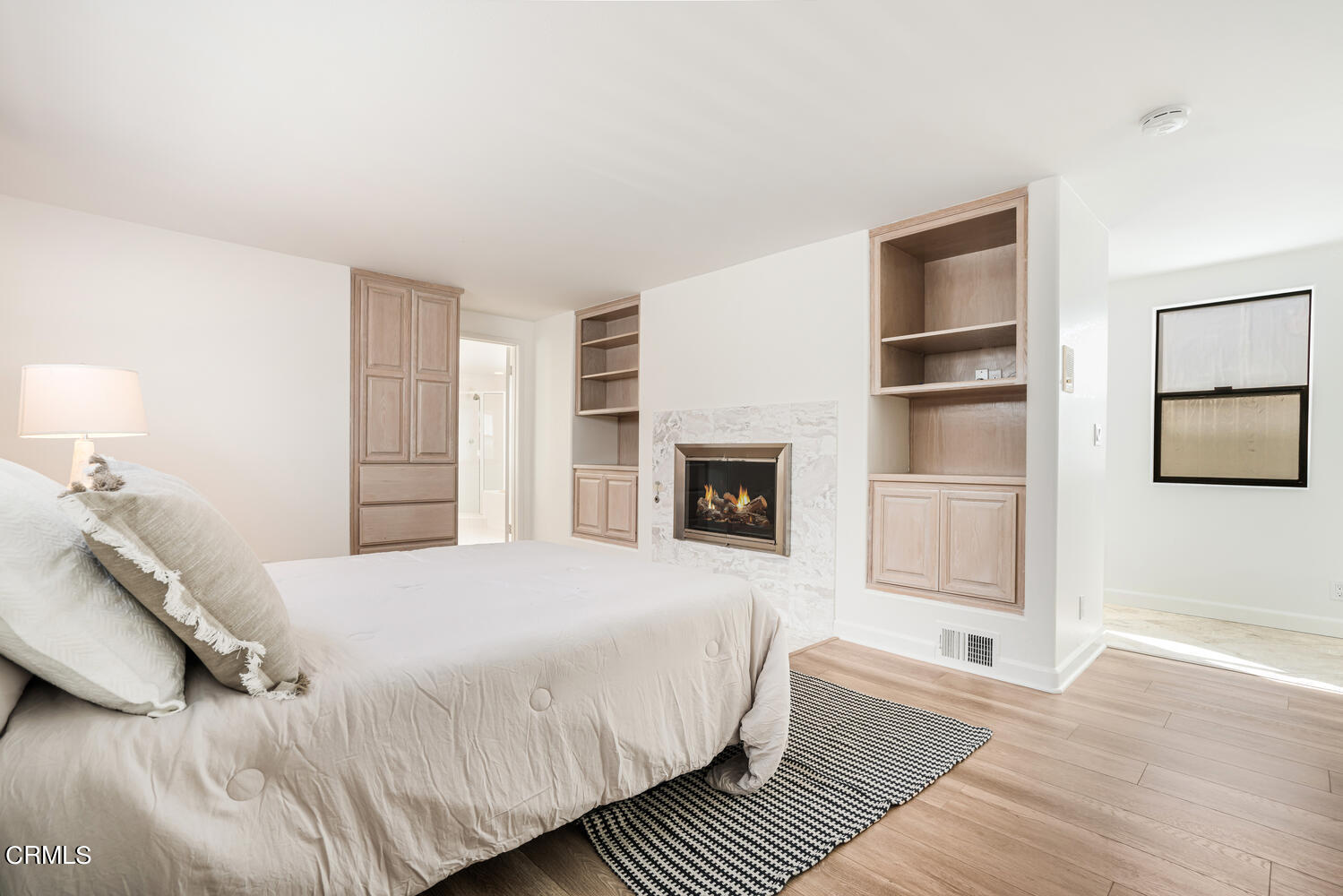 312 Melrose Drive Oxnard, CA 93035 - Photo 24 of 58 a spacious bedroom with a balcony a bed and a fireplace