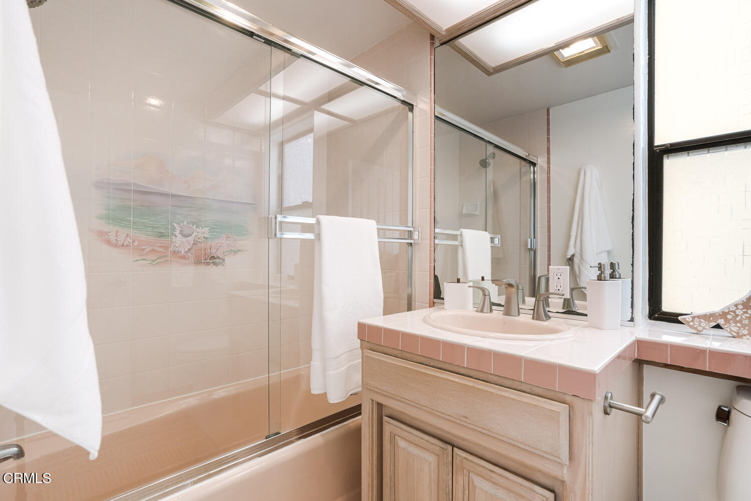312 Melrose Drive Oxnard, CA 93035 - Photo 30 of 58 a bathroom with a sink and a mirror