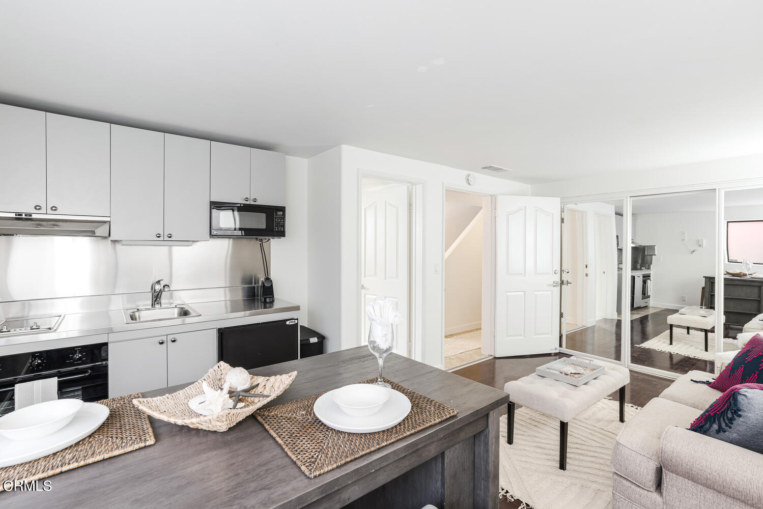 312 Melrose Drive Oxnard, CA 93035 - Photo 33 of 58 a kitchen with a table chairs stove and kitchen island