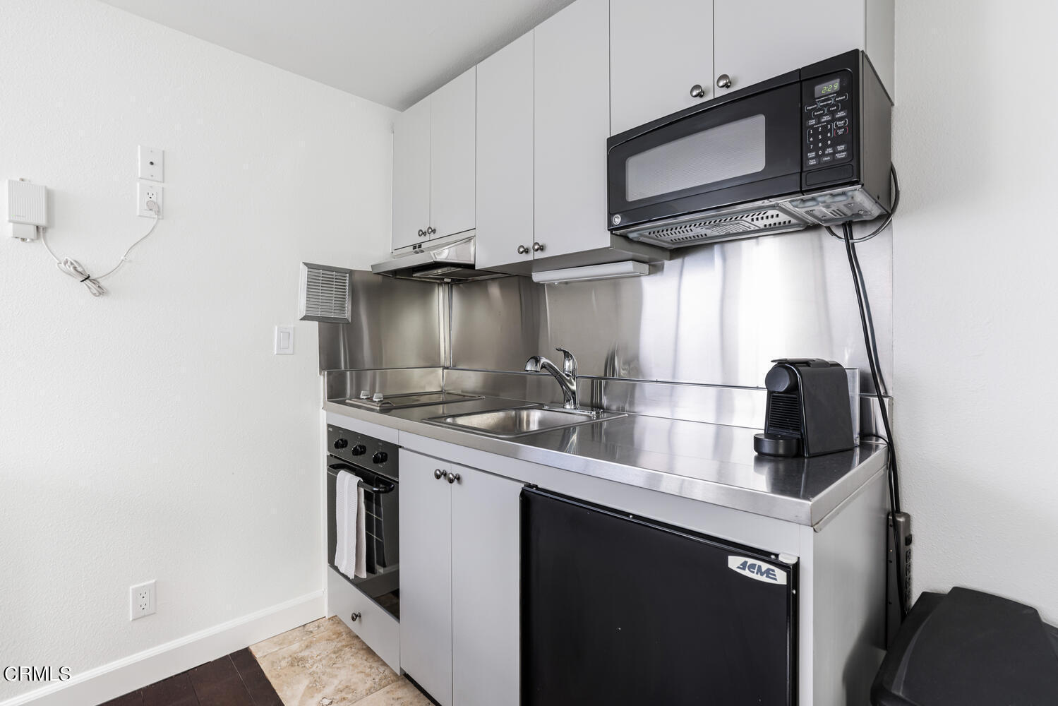 312 Melrose Drive Oxnard, CA 93035 - Photo 34 of 58 a kitchen with stainless steel appliances granite countertop a sink stove and microwave
