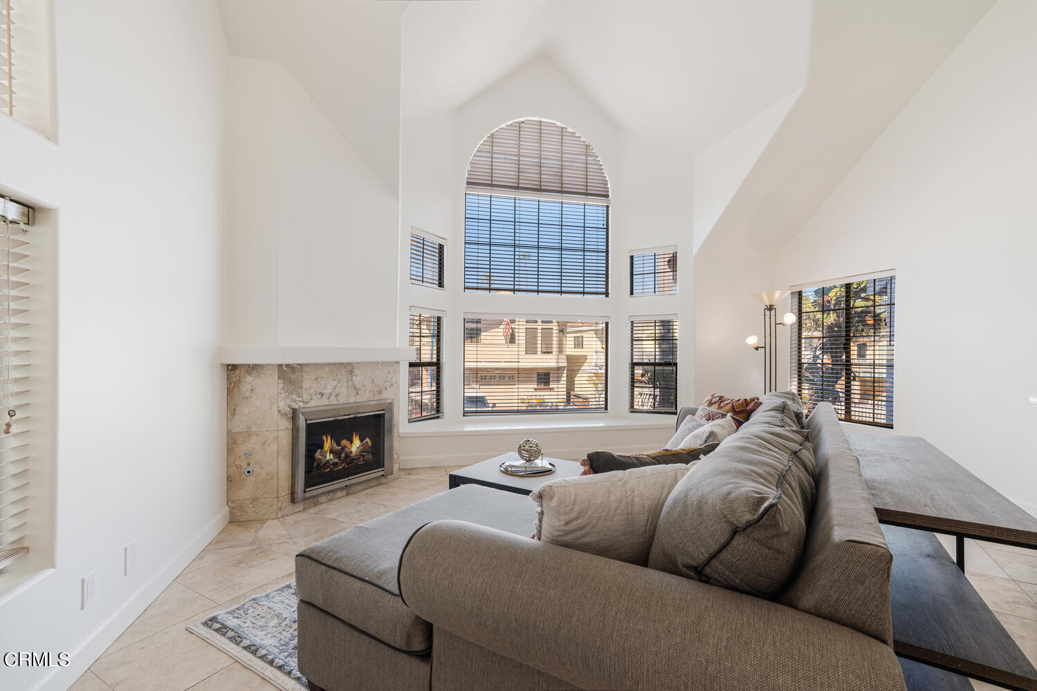 312 Melrose Drive Oxnard, CA 93035 - Photo 8 of 58 a living room with furniture a fireplace and a large window