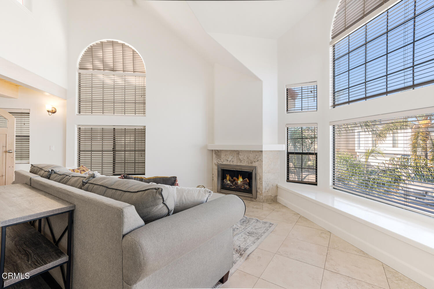 312 Melrose Drive Oxnard, CA 93035 - Photo 9 of 58 a living room with furniture a fireplace and a table