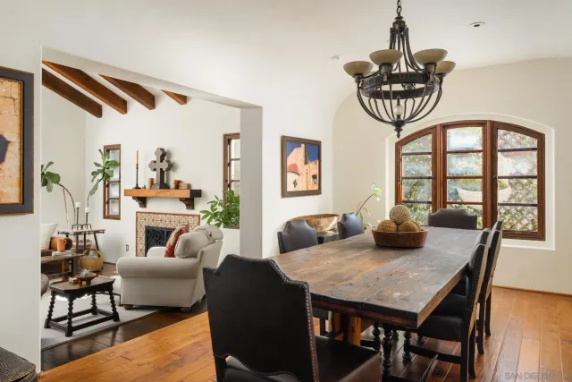 a view of a dining room with furniture a chandelier and wooden floor