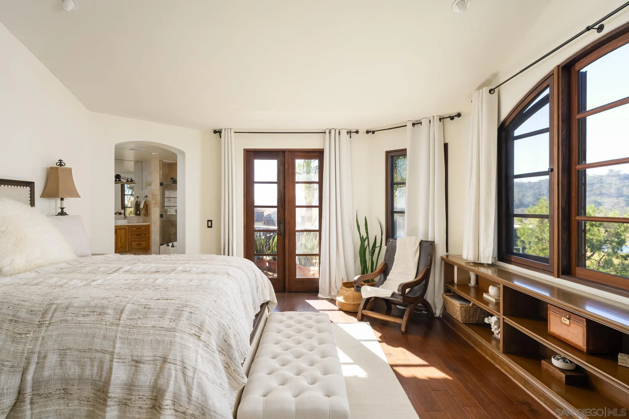 2563 Via Pisa Del Mar, CA 92014 - Photo 21 of 50 a bedroom with a bed and large windows