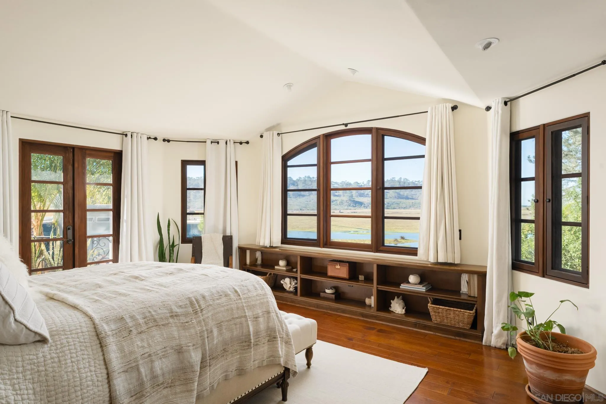 2563 Via Pisa Del Mar, CA 92014 - Photo 22 of 50 a spacious bedroom with a bed and a large window