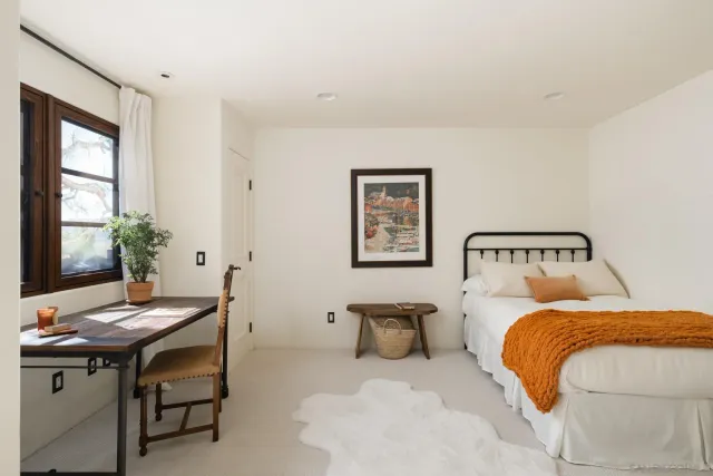 a bedroom with a bed and a table in it