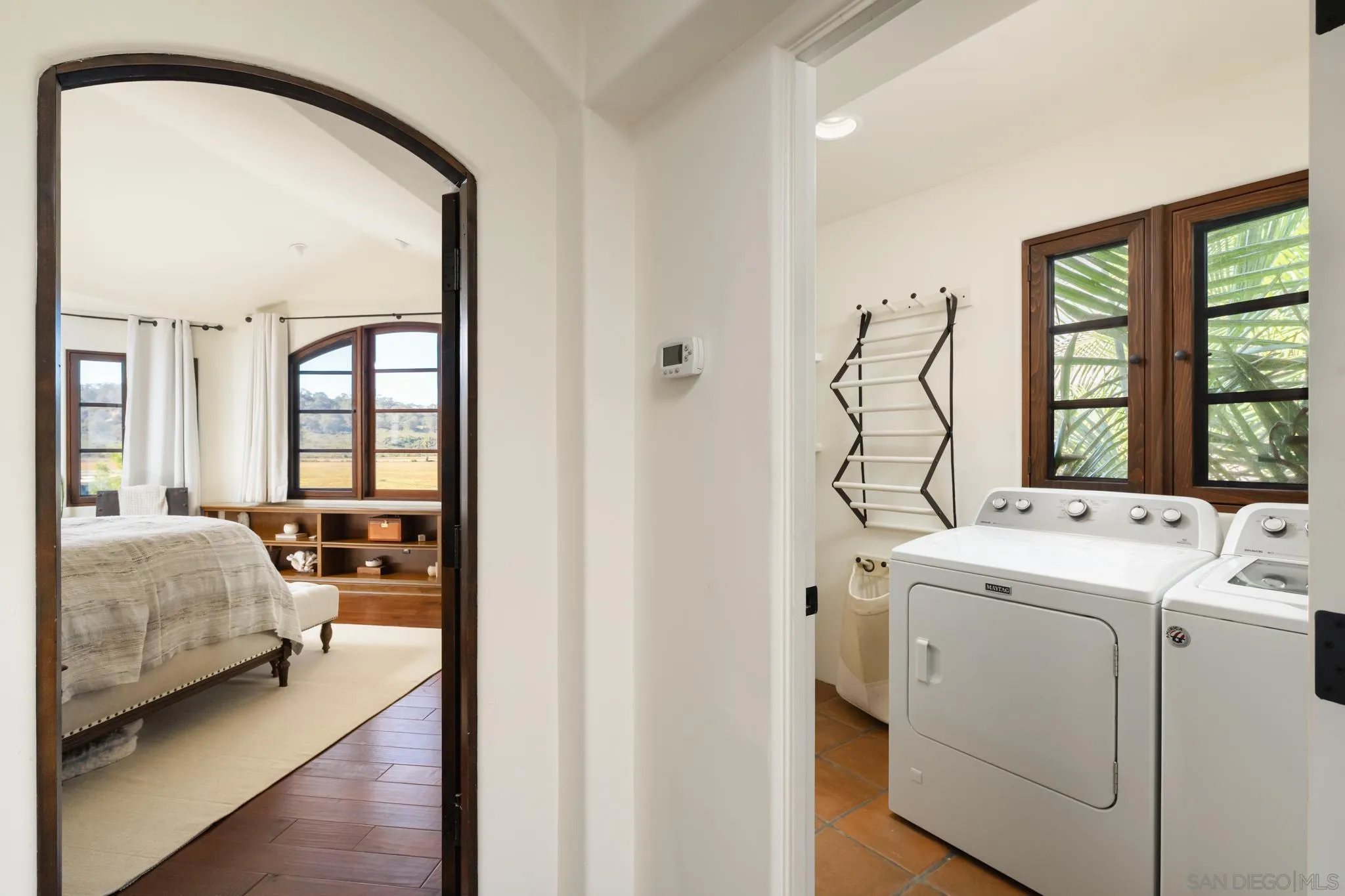 2563 Via Pisa Del Mar, CA 92014 - Photo 31 of 50 a view of a bedroom with a bed and a window