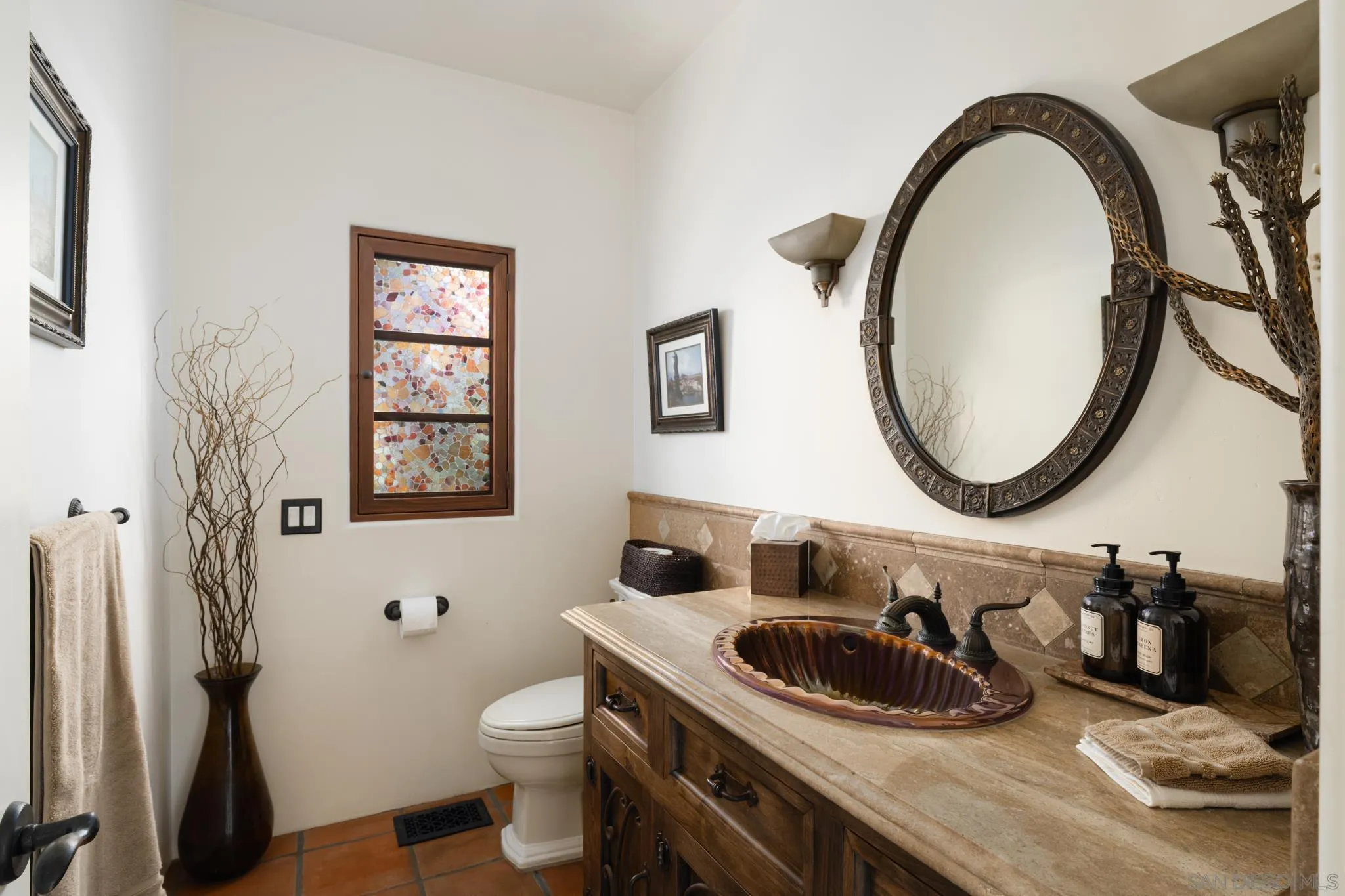 2563 Via Pisa Del Mar, CA 92014 - Photo 39 of 50 a bathroom with a toilet a sink and a mirror