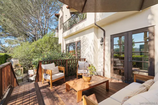 a backyard of a house with table and chairs