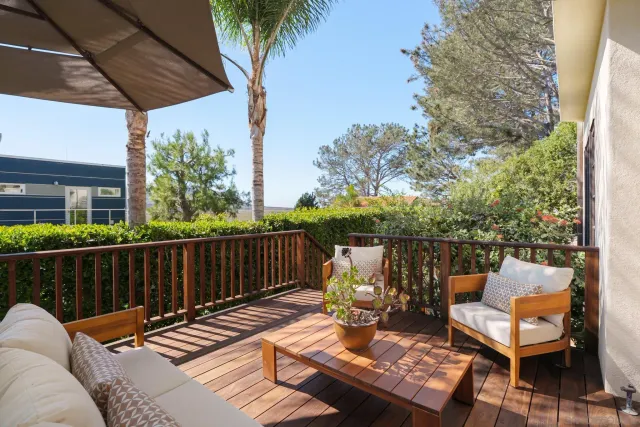 a view of a patio with table and chairs and potted plants