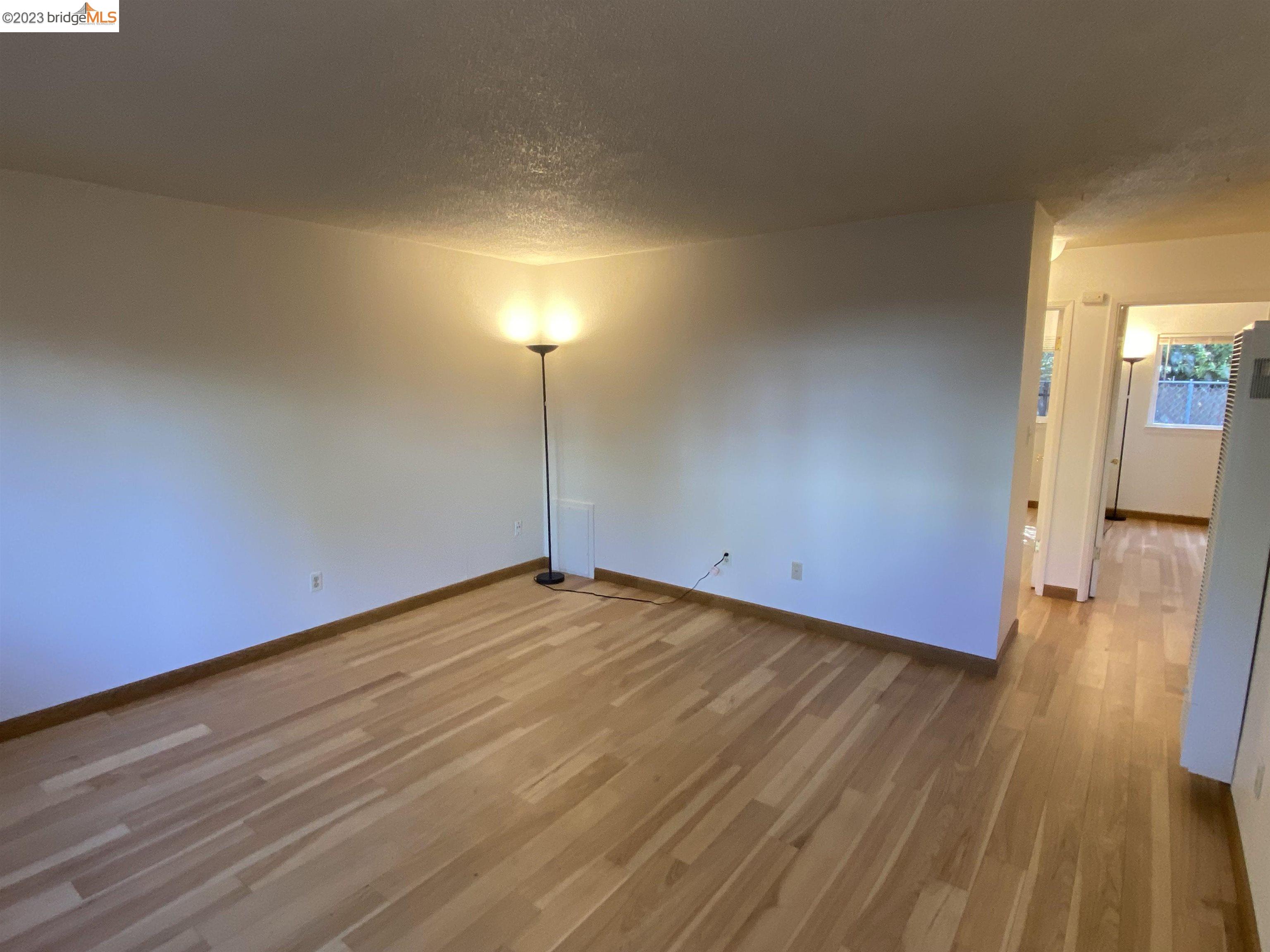 968 45th Street, Unit A Oakland, CA 94608 - Photo 3 of 16 a view of an empty room and wooden floor