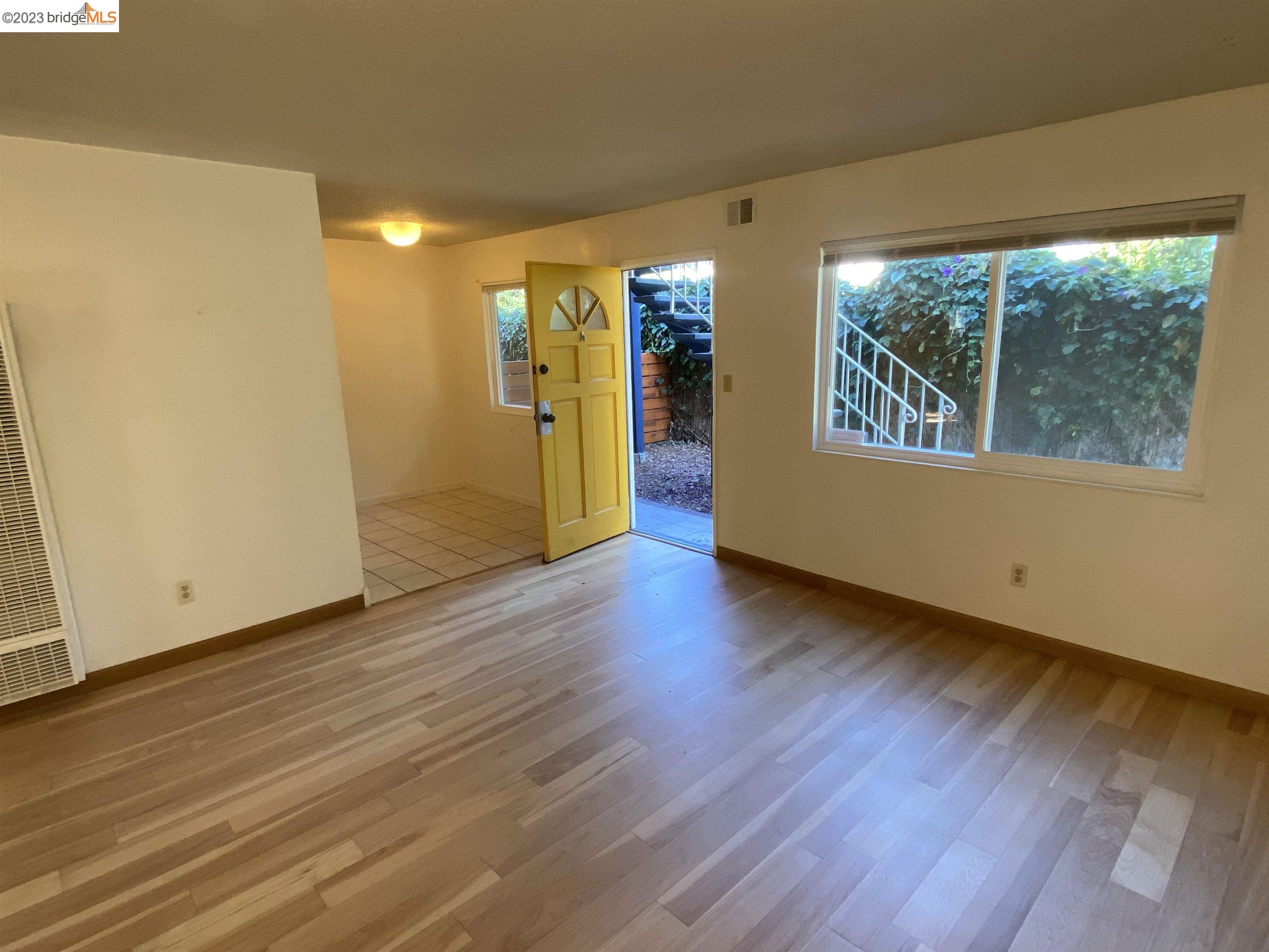 968 45th Street, Unit A Oakland, CA 94608 - Photo 4 of 16 a view of empty room with wooden floor and fan