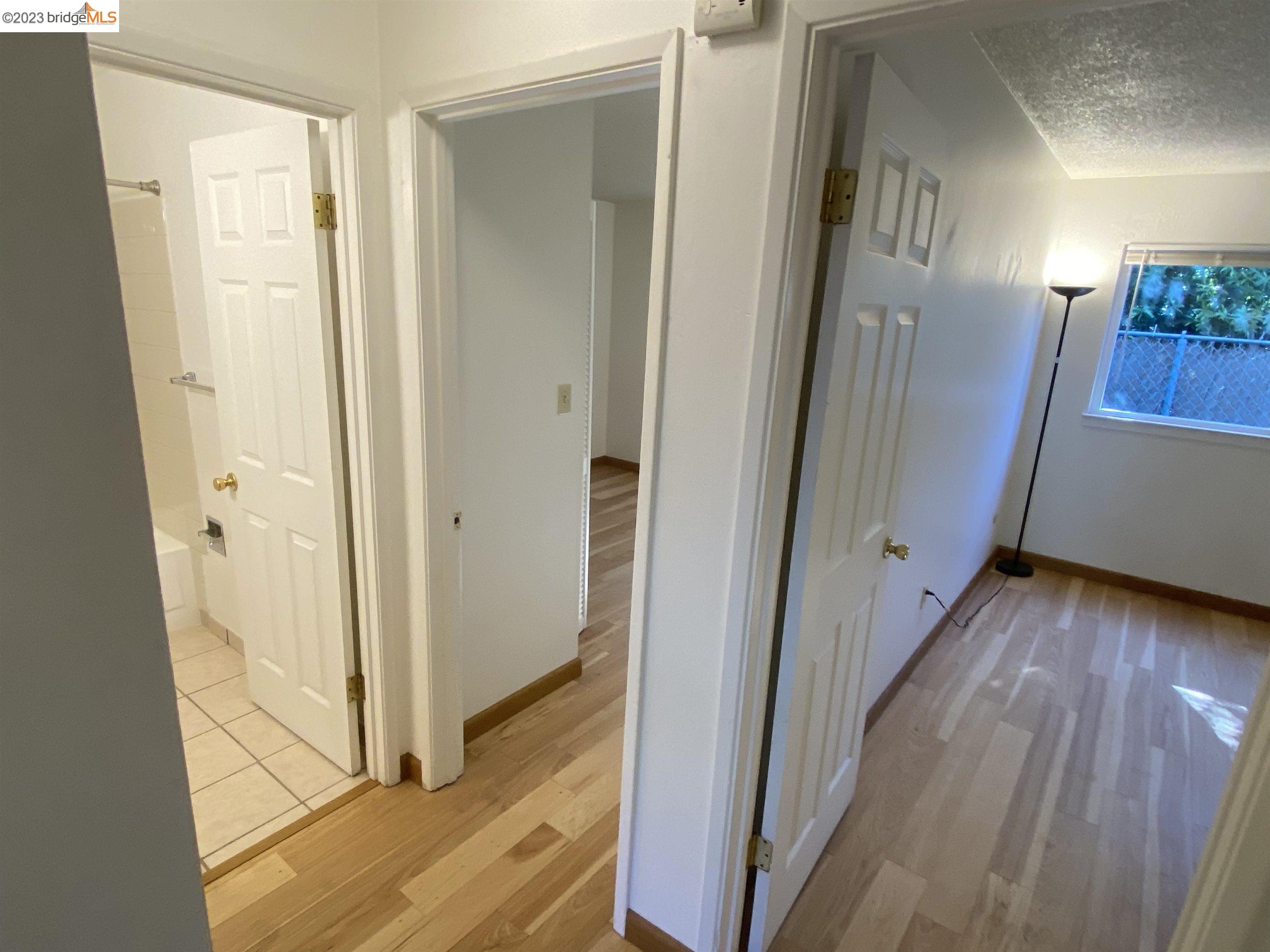 968 45th Street, Unit A Oakland, CA 94608 - Photo 9 of 16 a view of a hallway with wooden floor and staircase
