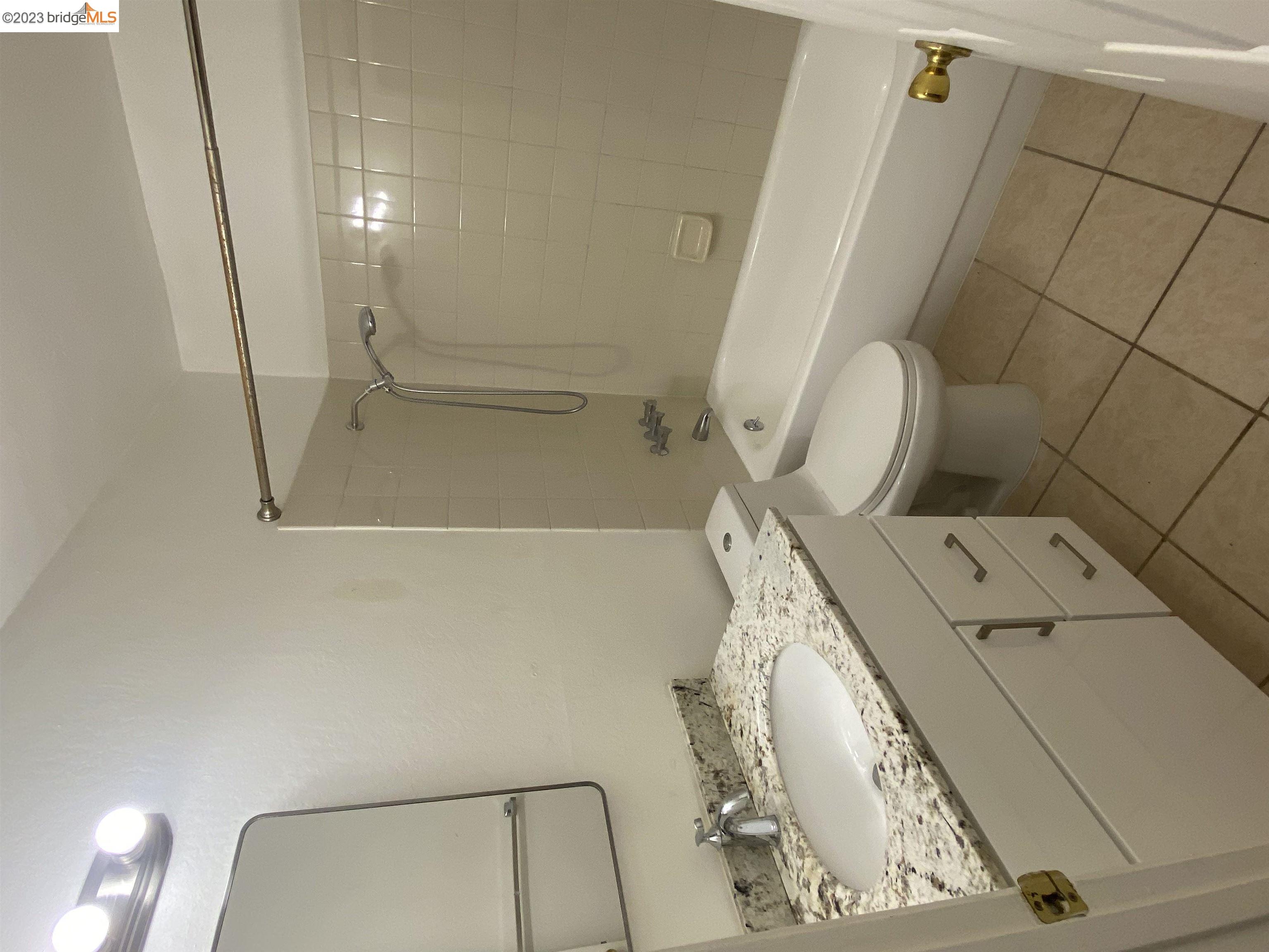 968 45th Street, Unit A Oakland, CA 94608 - Photo 10 of 16 a bathroom with a sink and mirror