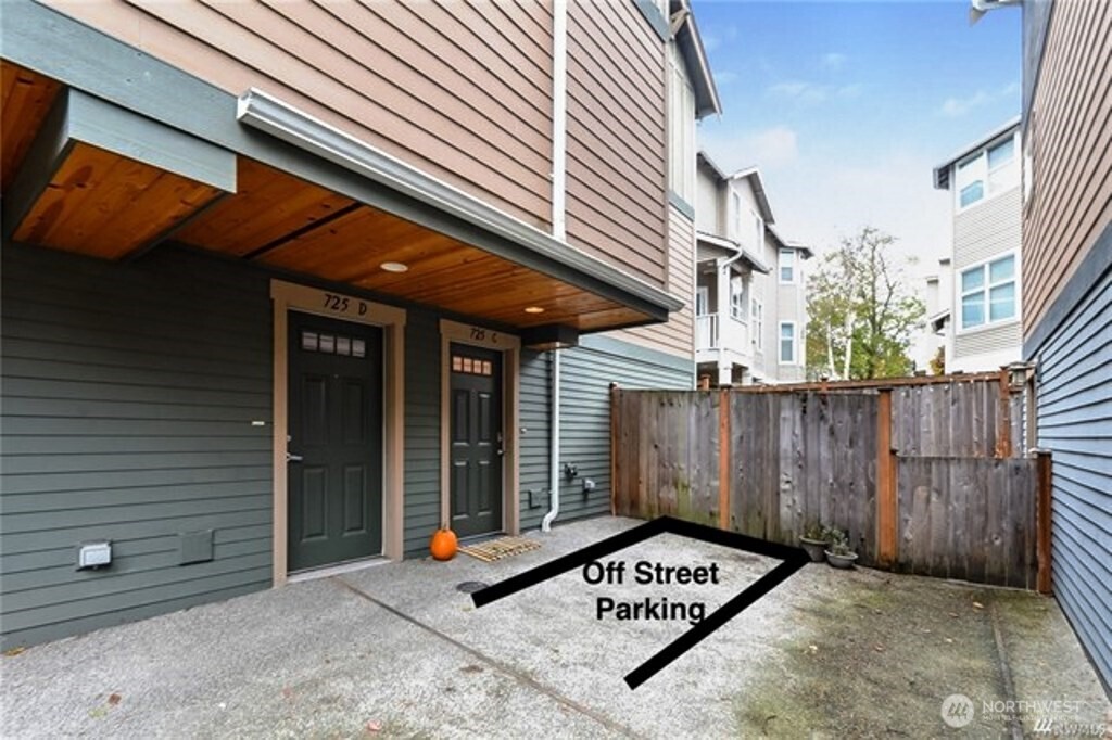 725 North 95th Street, Unit C Seattle, WA 98103 - Photo 18 of 18 a view of a wooden door with a bench and wooden fence