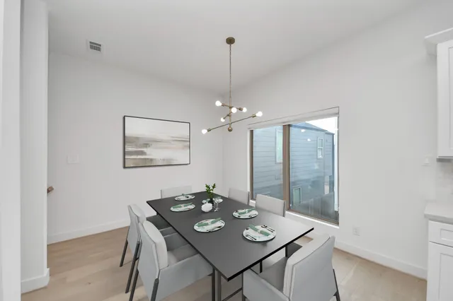a view of a dining room with furniture and chandelier