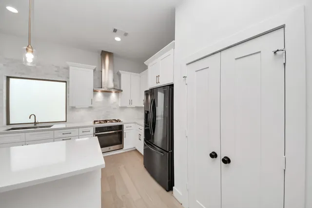 a kitchen with a refrigerator stove and sink
