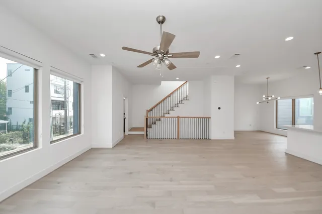a view of a livingroom with a ceiling fan and window