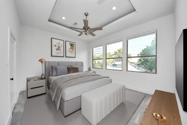 a spacious bedroom with a bed and a large window